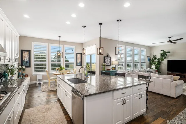 a kitchen with stainless steel appliances granite countertop a sink and stove