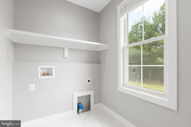 a kitchen with a sink a window and chairs