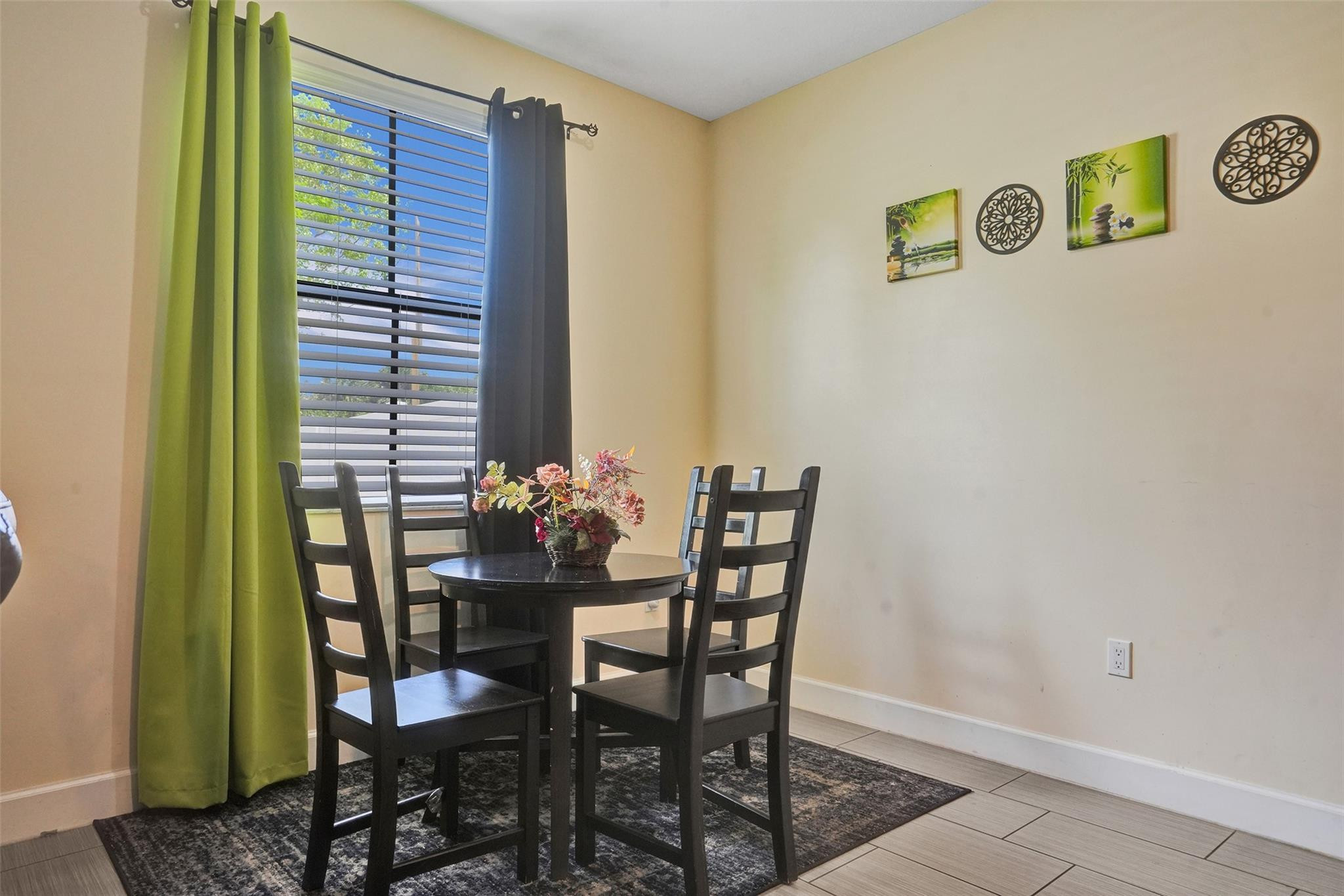 4875 Northwest 55th Place Tamarac, FL 33319 - Photo 14 of 44 a view of a dining room with furniture and window