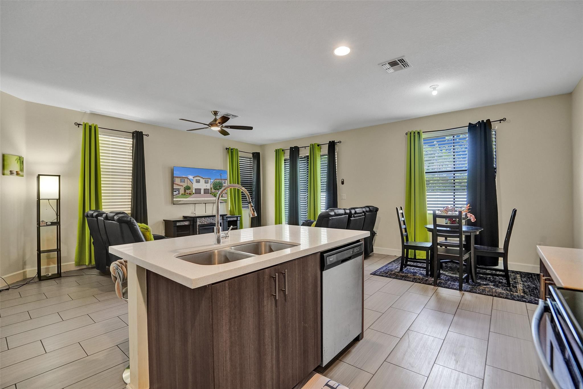 4875 Northwest 55th Place Tamarac, FL 33319 - Photo 20 of 44 a room with a table chairs and a refrigerator