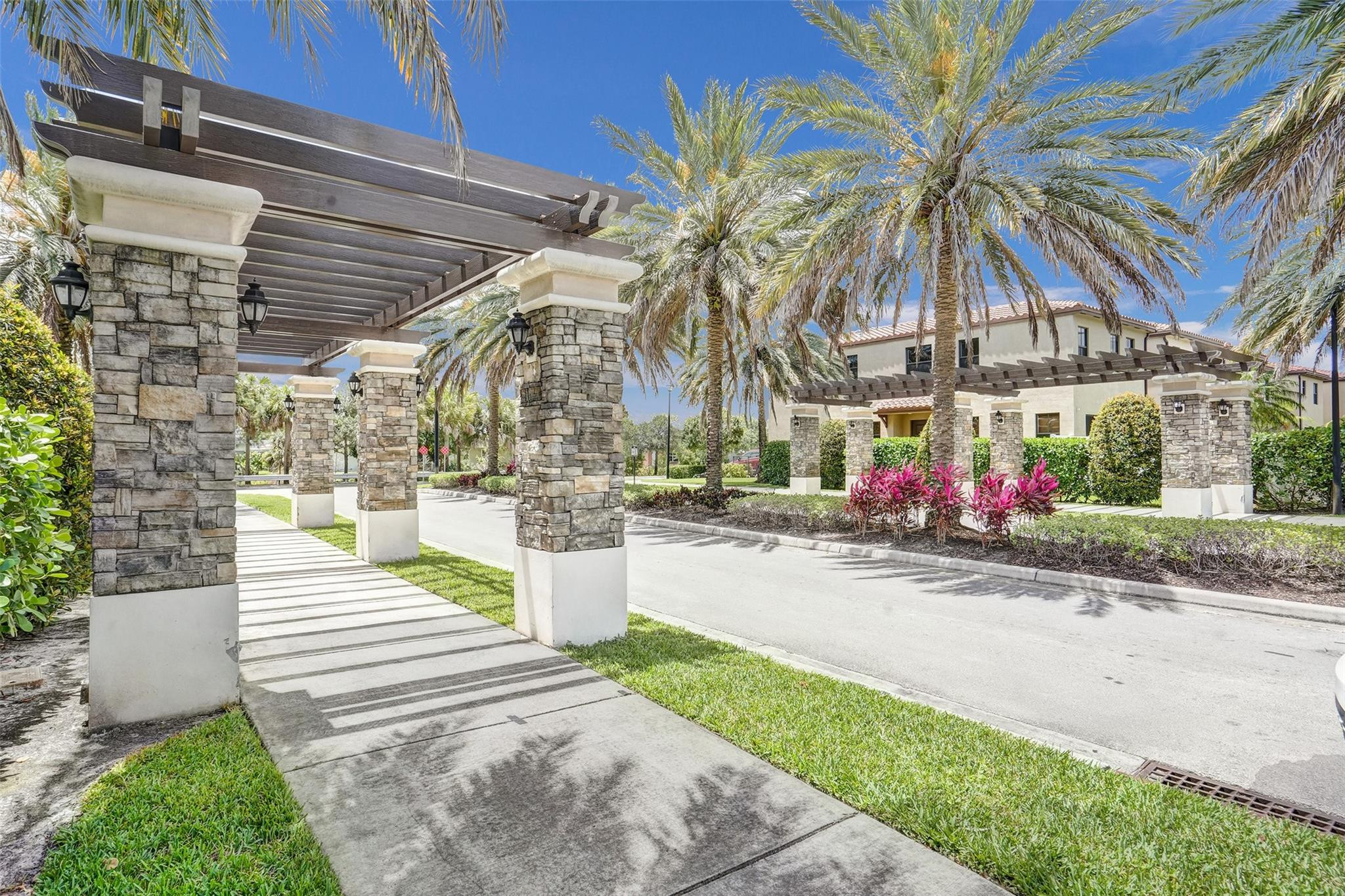 4875 Northwest 55th Place Tamarac, FL 33319 - Photo 2 of 44 a front view of a house with a garden and patio