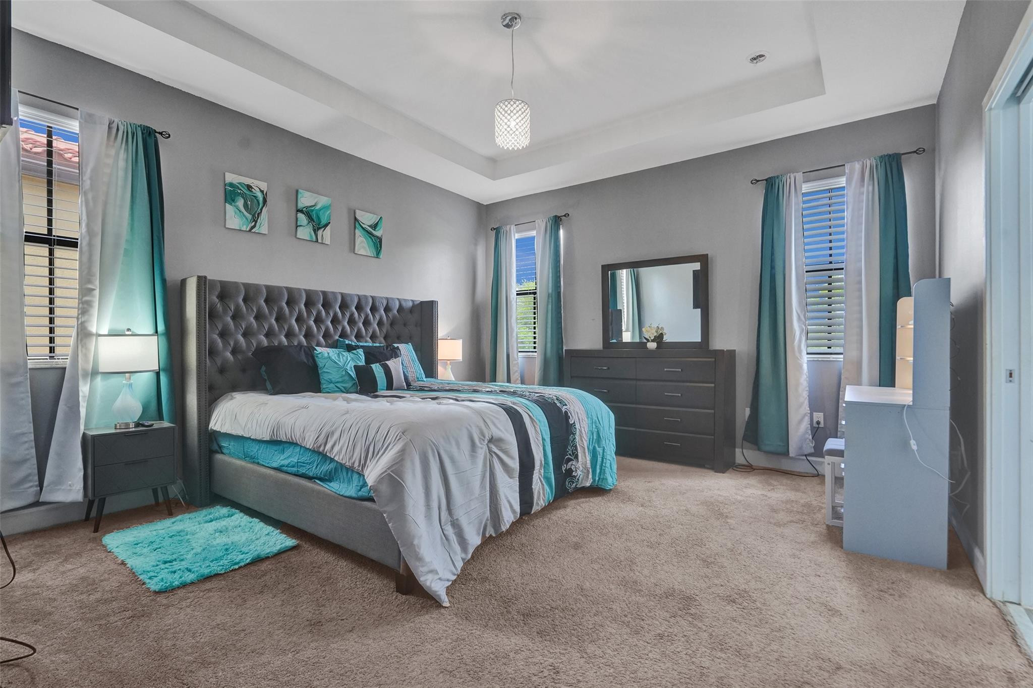 4875 Northwest 55th Place Tamarac, FL 33319 - Photo 24 of 44 a bedroom with a bed and a chandelier