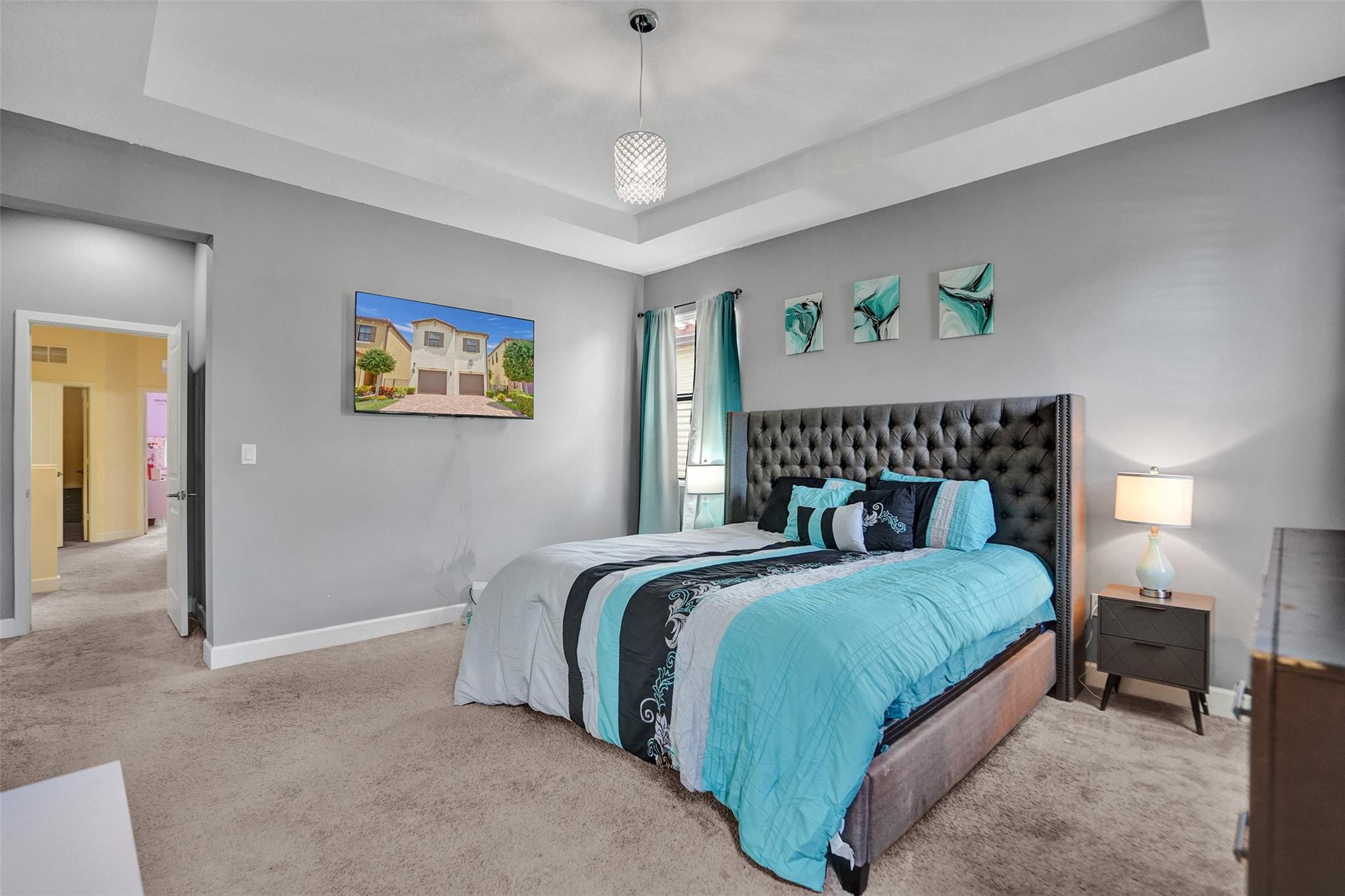 4875 Northwest 55th Place Tamarac, FL 33319 - Photo 25 of 44 a bedroom with bed and a chandelier