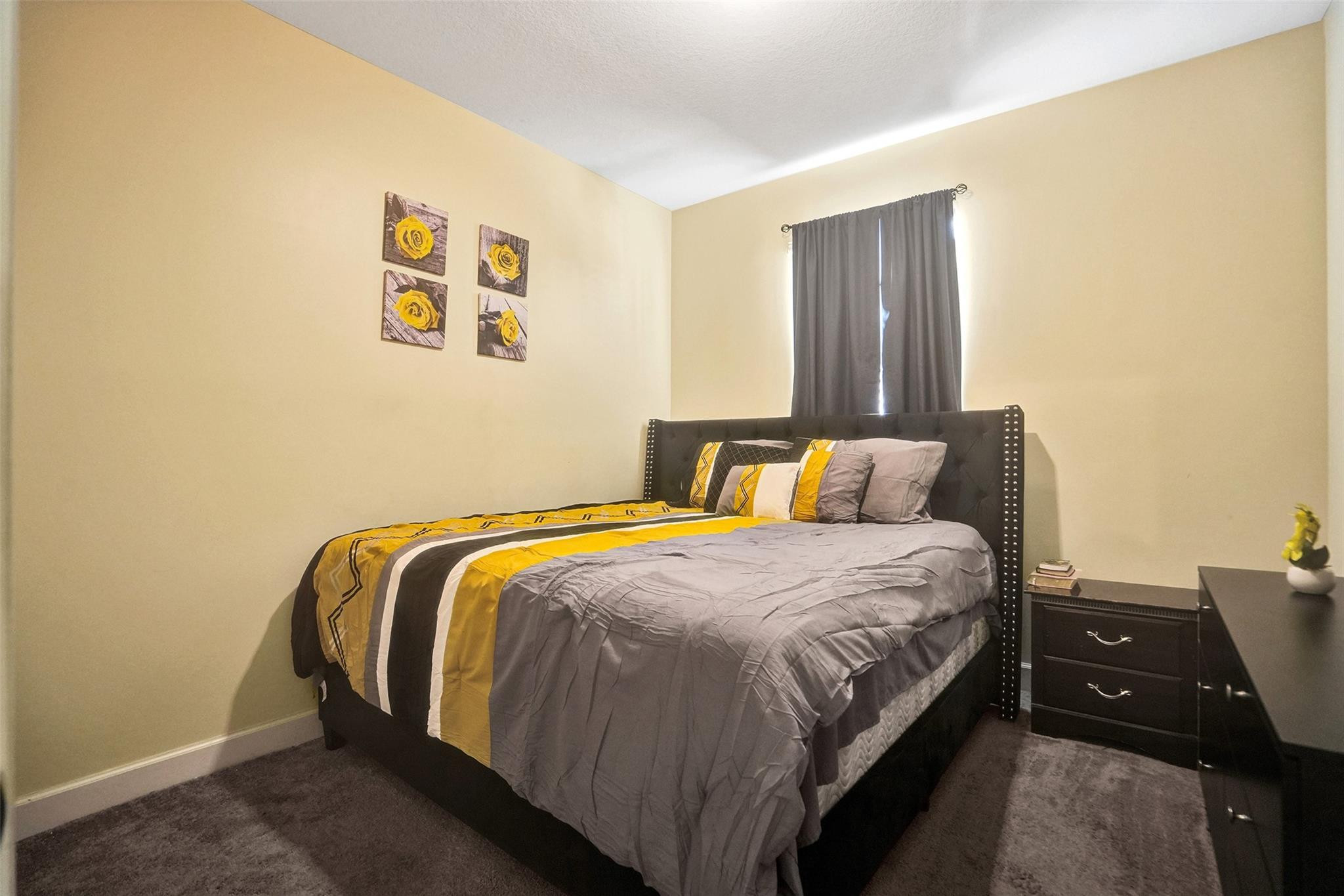 4875 Northwest 55th Place Tamarac, FL 33319 - Photo 29 of 44 a bed sitting in a bedroom next to a window