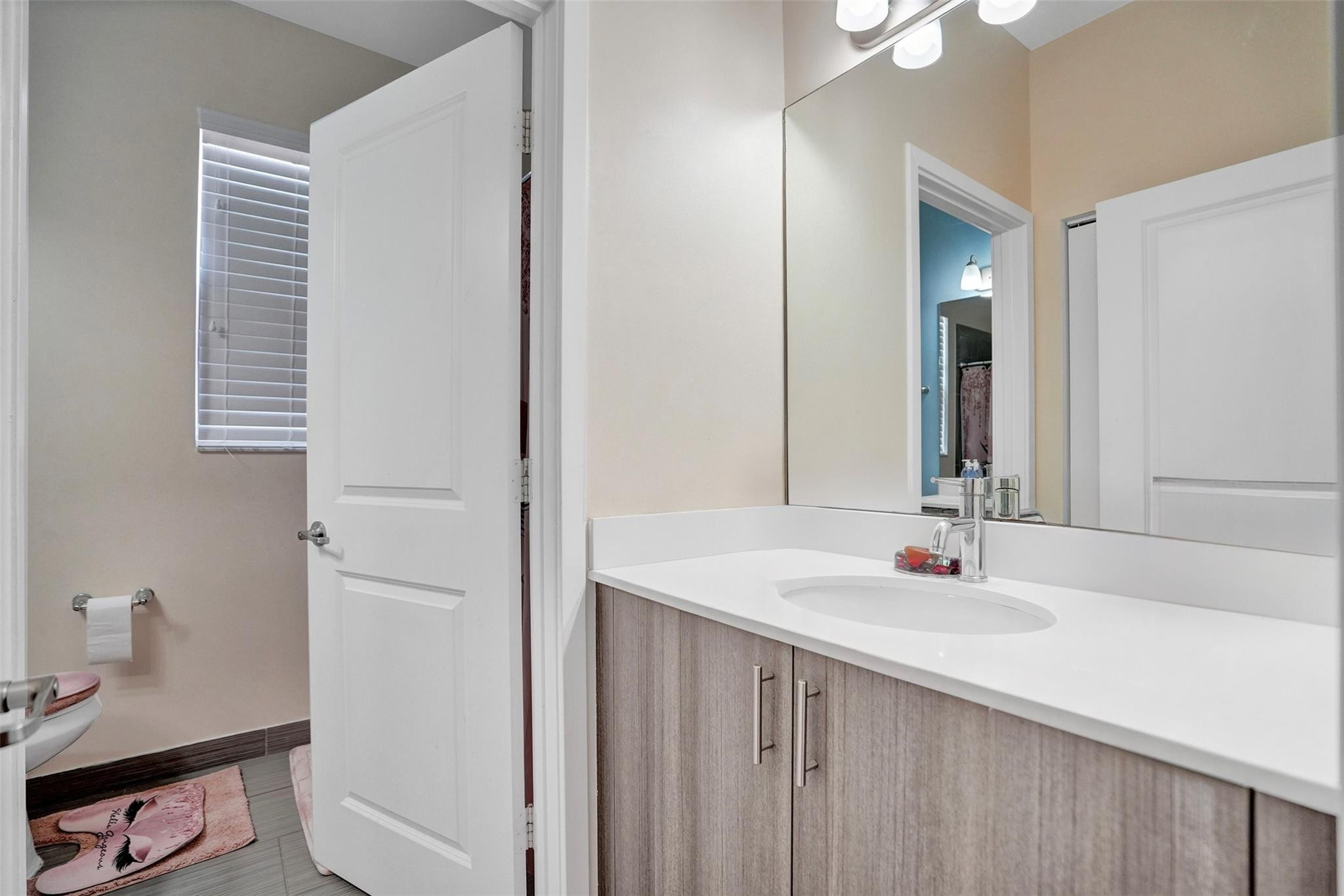 4875 Northwest 55th Place Tamarac, FL 33319 - Photo 34 of 44 a bathroom with a sink vanity and a mirror