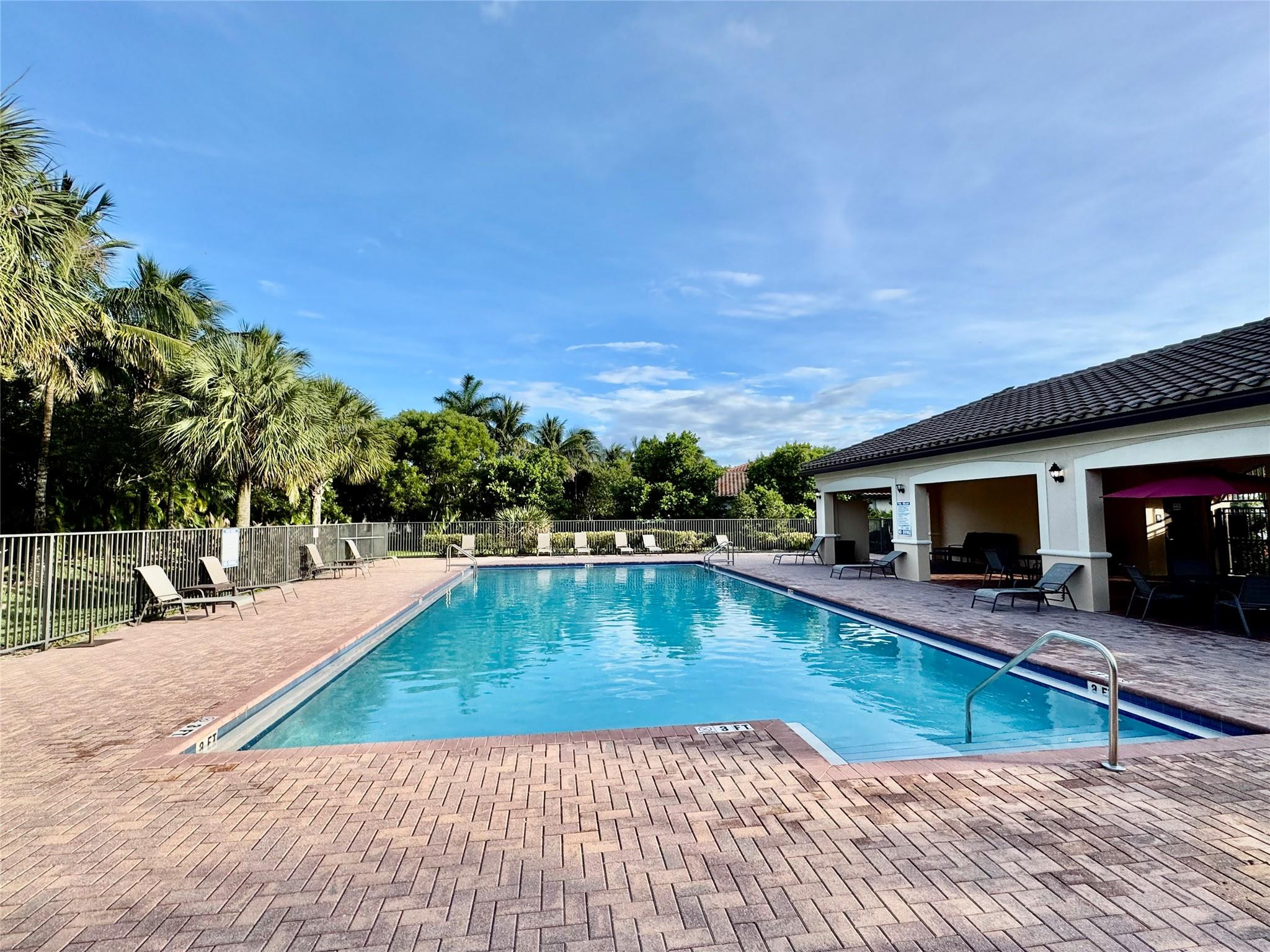 4875 Northwest 55th Place Tamarac, FL 33319 - Photo 41 of 44 a view of a swimming pool with lounge chair