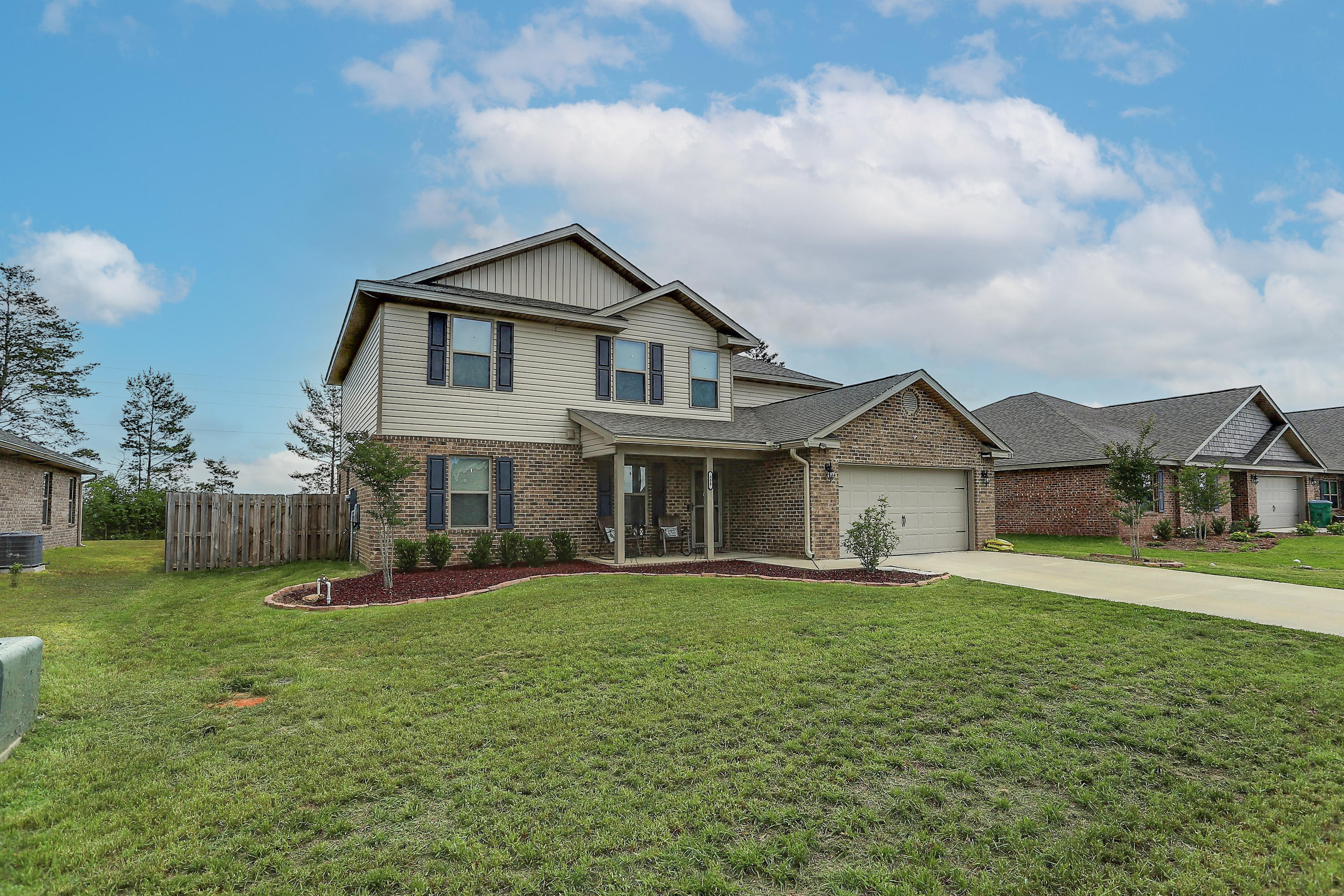 358 Merlin Court Crestview, FL 32539 - Photo 2 of 45 a view of a yard in front of a house with large windows