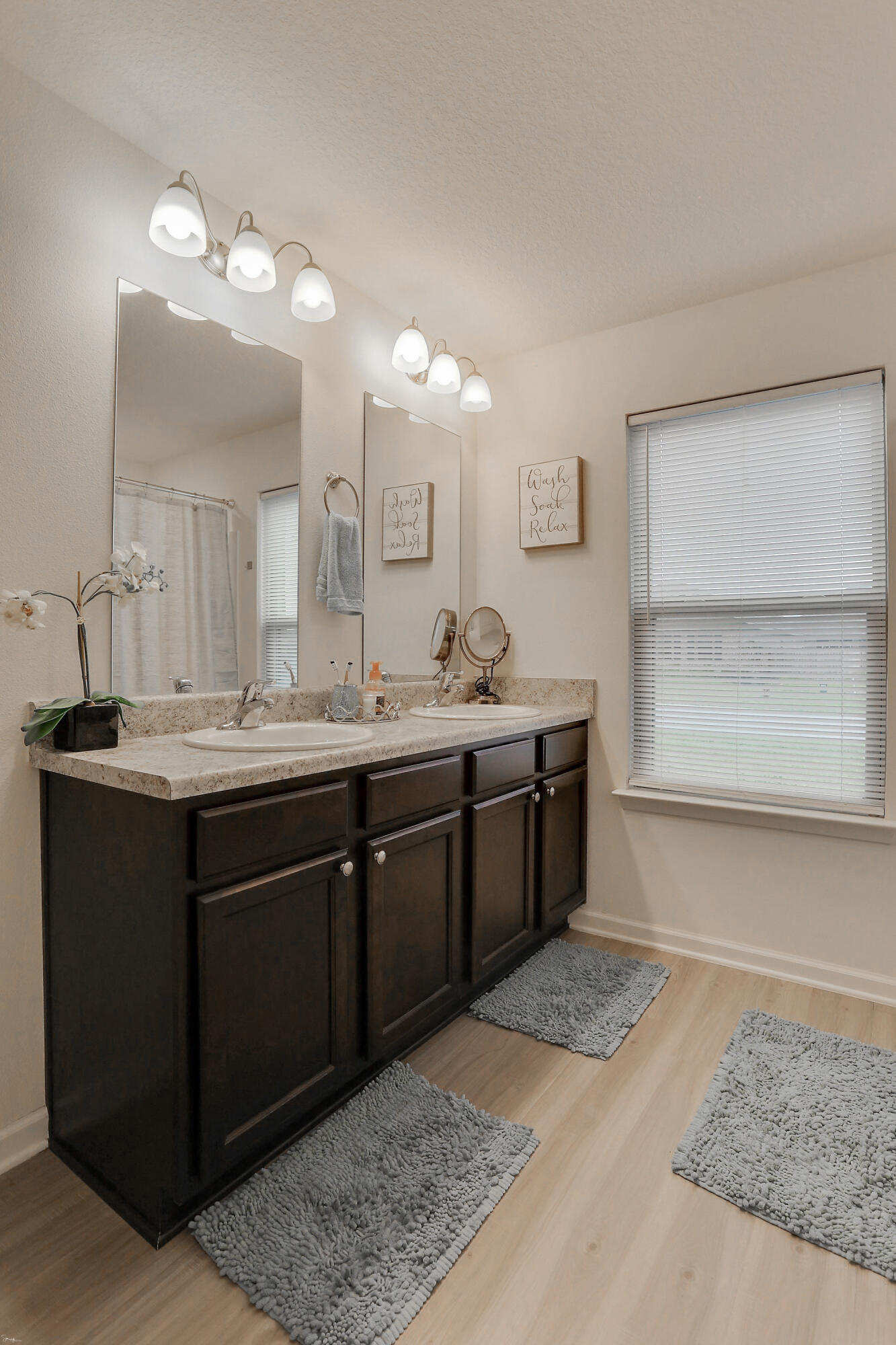 358 Merlin Court Crestview, FL 32539 - Photo 27 of 45 a bathroom with a double vanity sink and a mirror