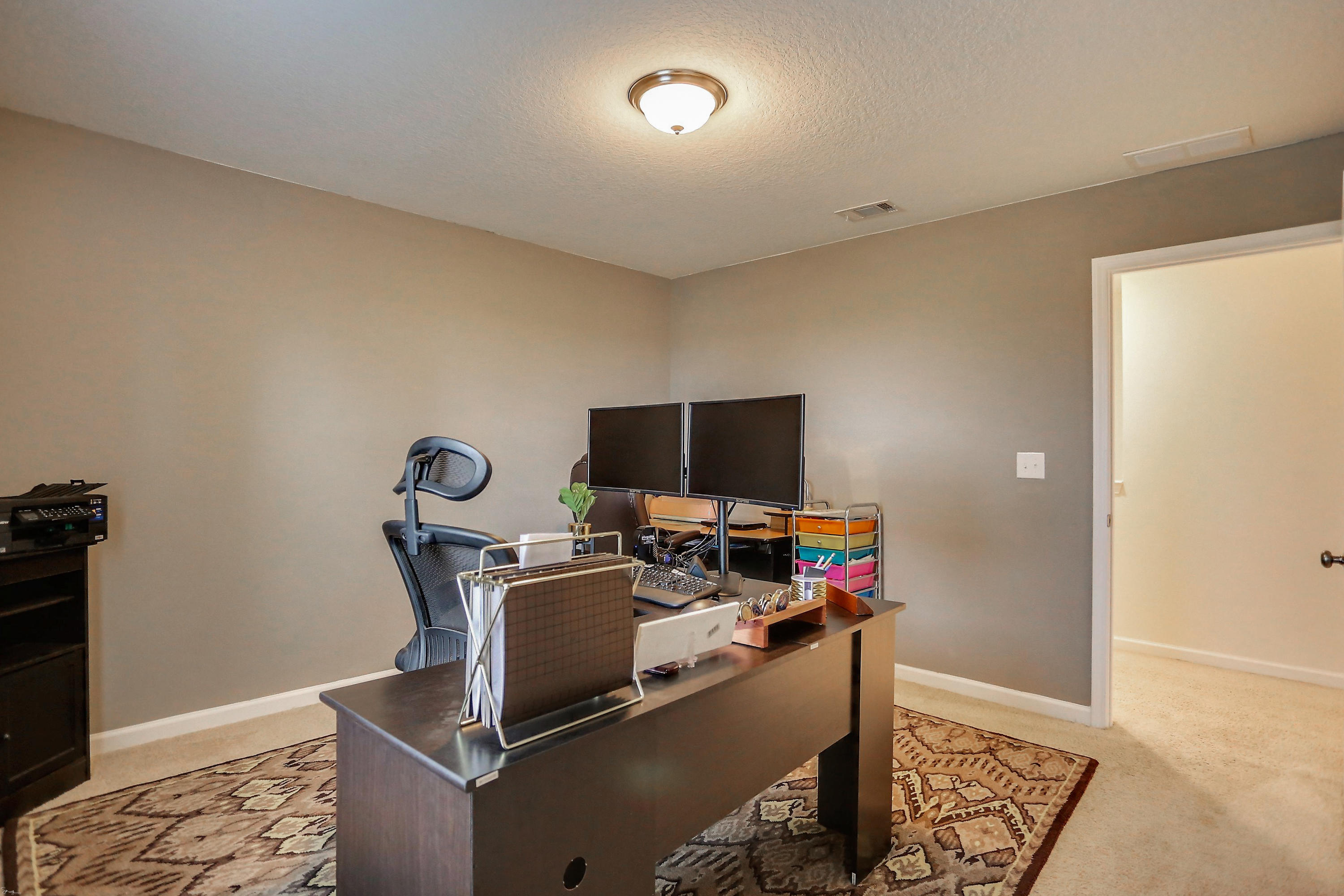 358 Merlin Court Crestview, FL 32539 - Photo 33 of 45 a view of a workspace with furniture and a flat screen tv
