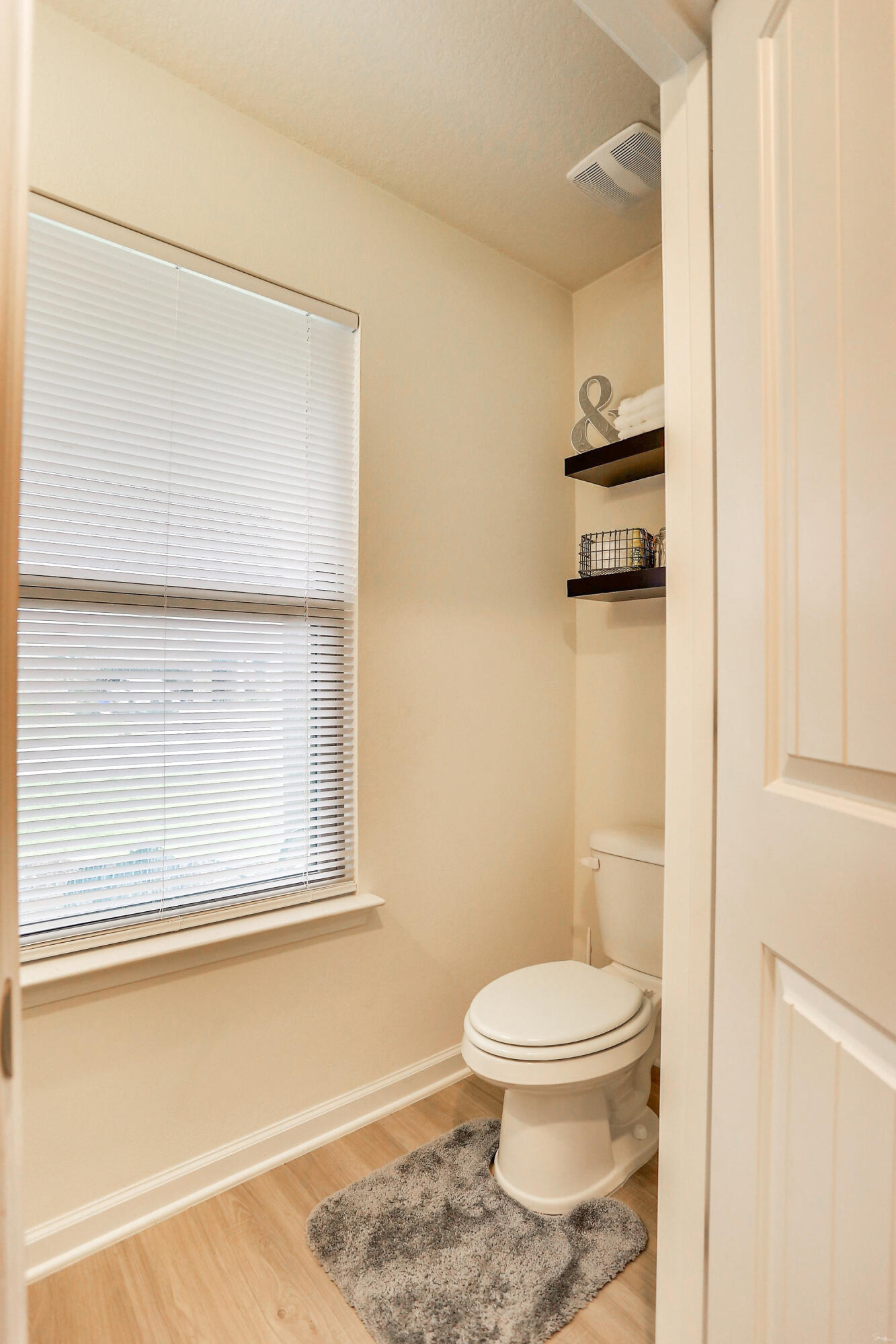 358 Merlin Court Crestview, FL 32539 - Photo 8 of 45 a bathroom with a toilet a sink and a window