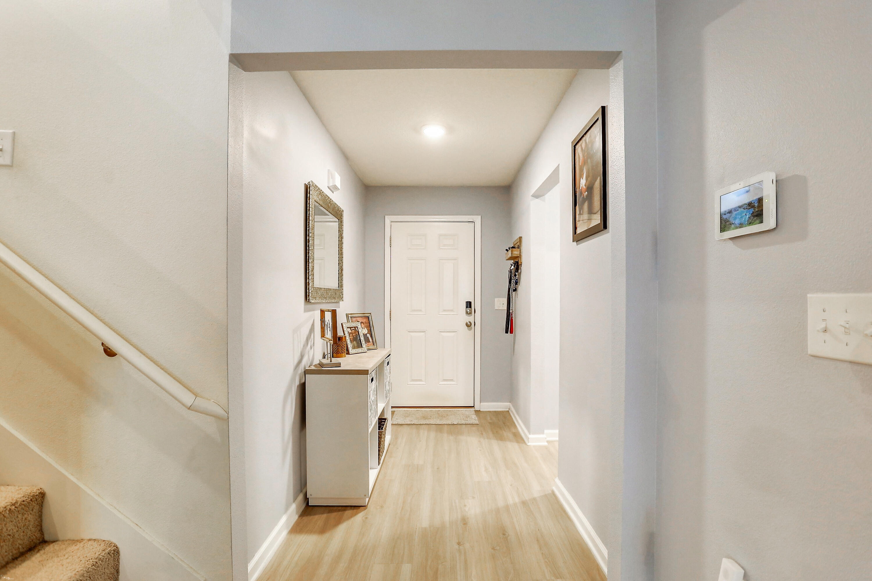 358 Merlin Court Crestview, FL 32539 - Photo 9 of 45 a view of a hallway with wooden floor and furniture