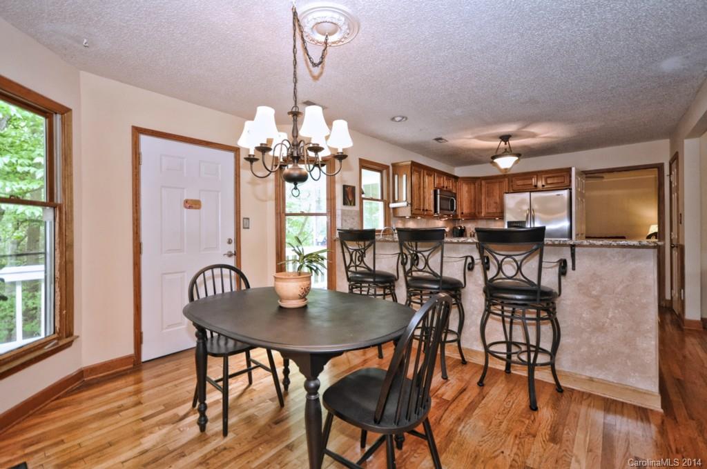 31017 Executive Point Tega Cay, SC 29708 - Photo 12 of 22 a view of a dining room with furniture window and wooden floor