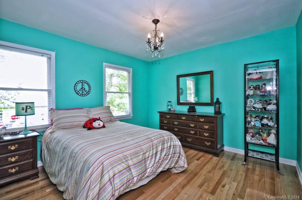 31017 Executive Point Tega Cay, SC 29708 - Photo 14 of 22 a bedroom with two beds and a dresser with mirror