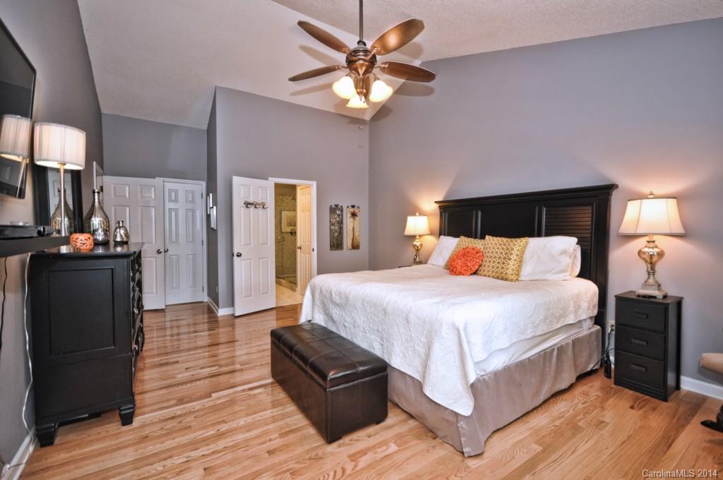 31017 Executive Point Tega Cay, SC 29708 - Photo 5 of 22 a bed room with a bed and a chandelier