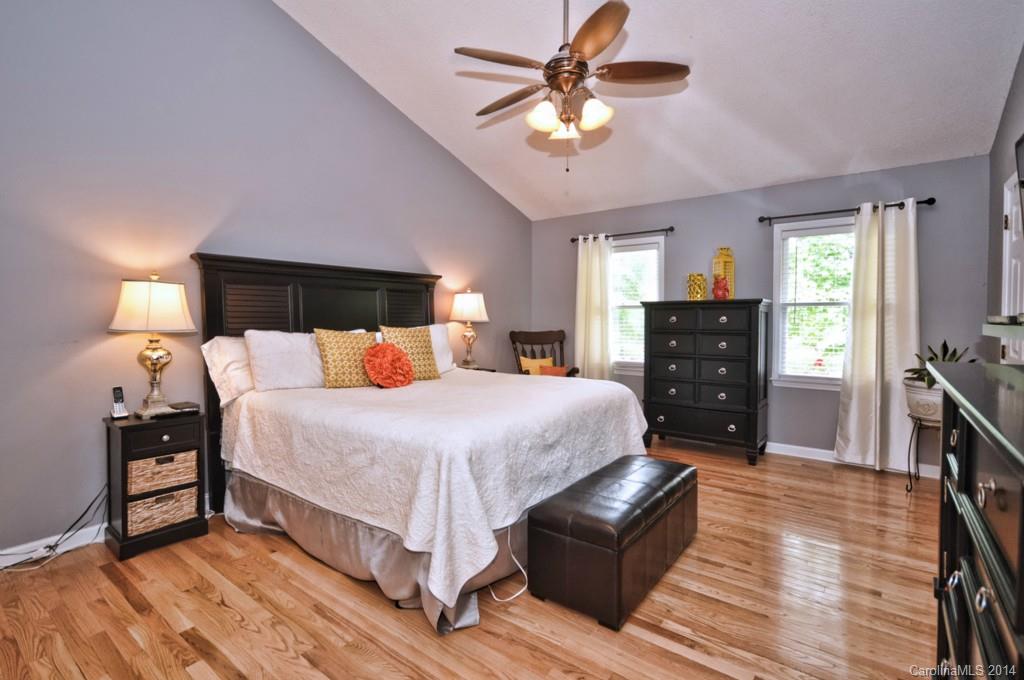 31017 Executive Point Tega Cay, SC 29708 - Photo 6 of 22 a bedroom with a bed and wooden floor