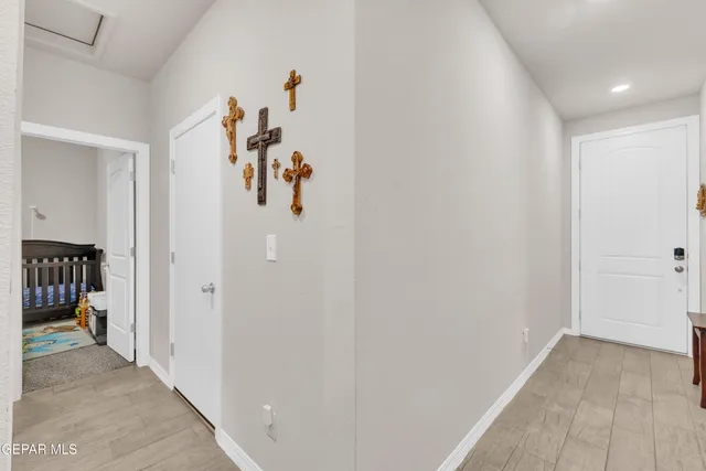 a view of a hallway with closet and a couch