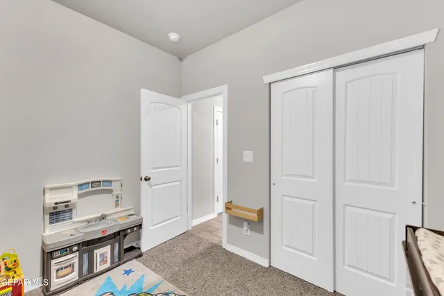 a room that has a bed and a dresser in it