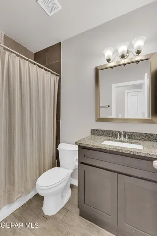 a bathroom with a toilet a sink and a mirror