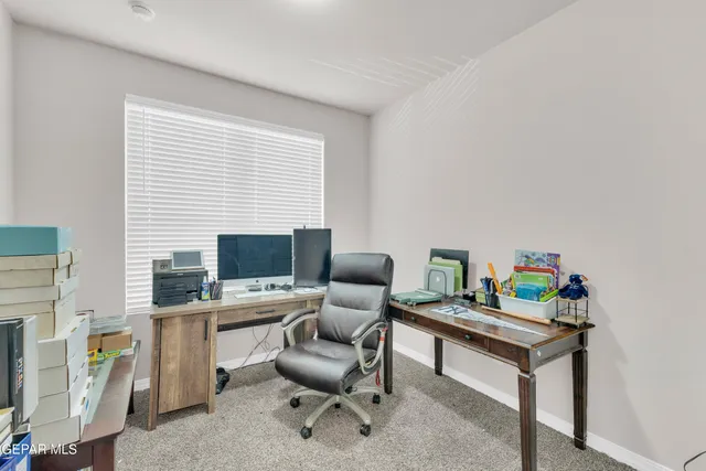 a work room with furniture and a window