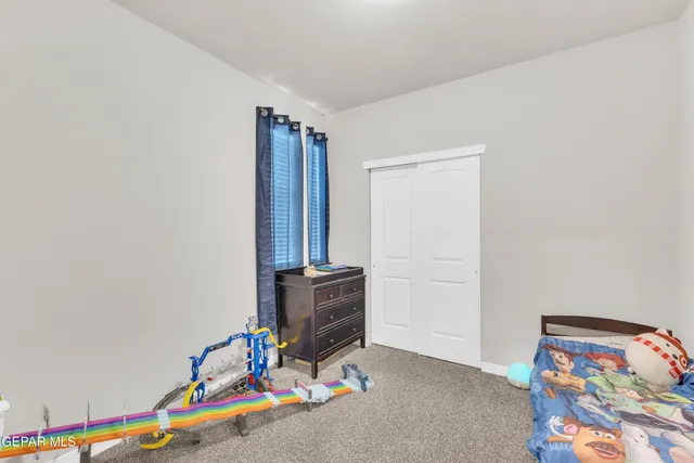 a bedroom with furniture and painting on the wall