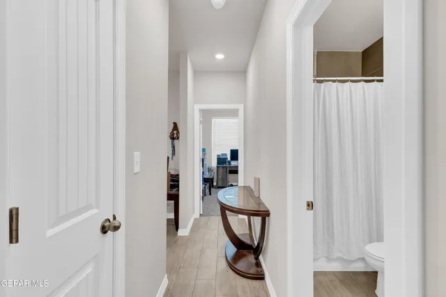 a bedroom with a bed and a night stand