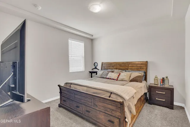 a bedroom with a bed and ceiling fan