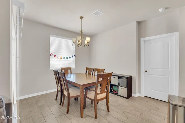a view of a dining room with furniture and chandelier