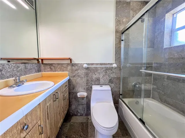 a bathroom with a sink a toilet and bathtub