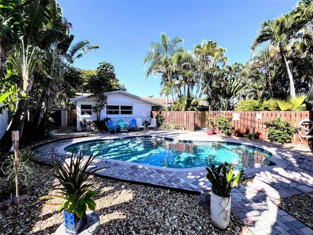 a view of a house with a yard and sitting area