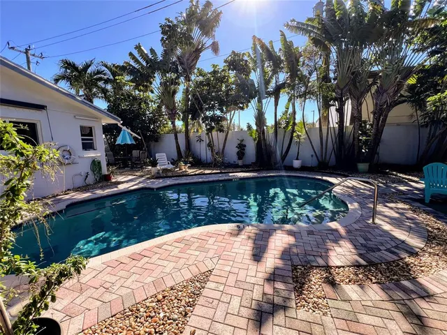 a backyard of a house with lots of green space and fountain