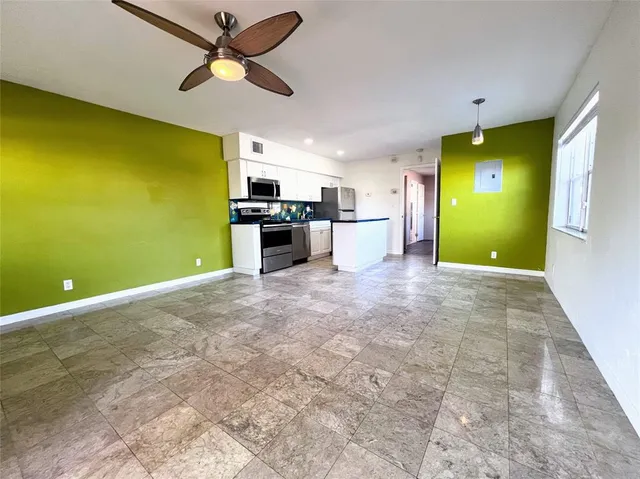 a view of a livingroom with a kitchen