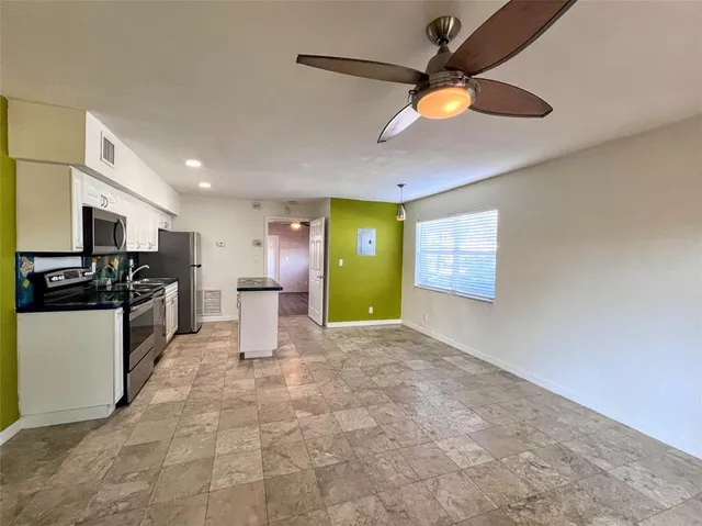 a kitchen with a refrigerator and microwave