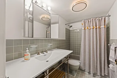 a bathroom with a sink a toilet and mirror