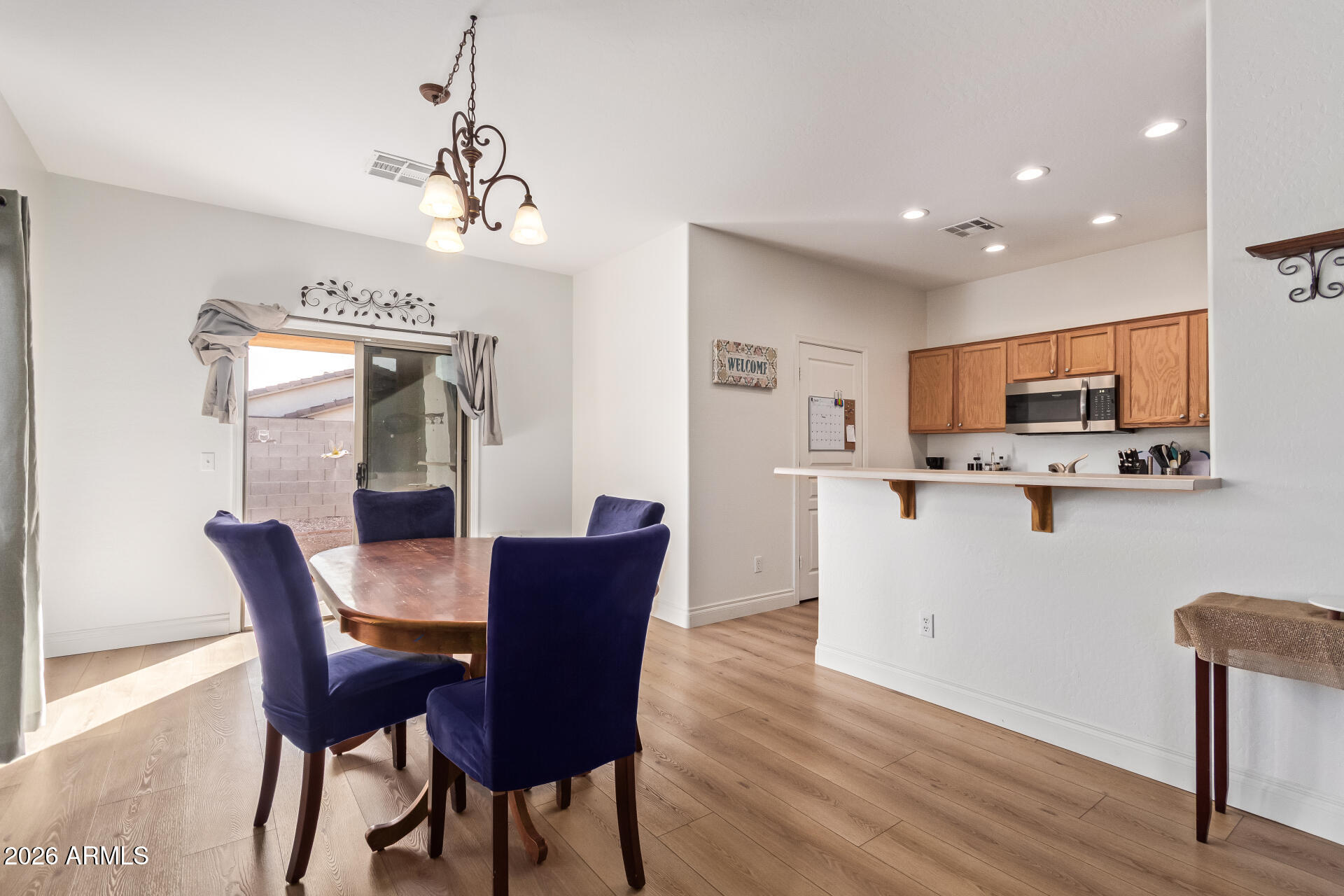 16805 West Rimrock Street Surprise, AZ 85388 - Photo 11 of 42 a view of a dining room with furniture and wooden floor