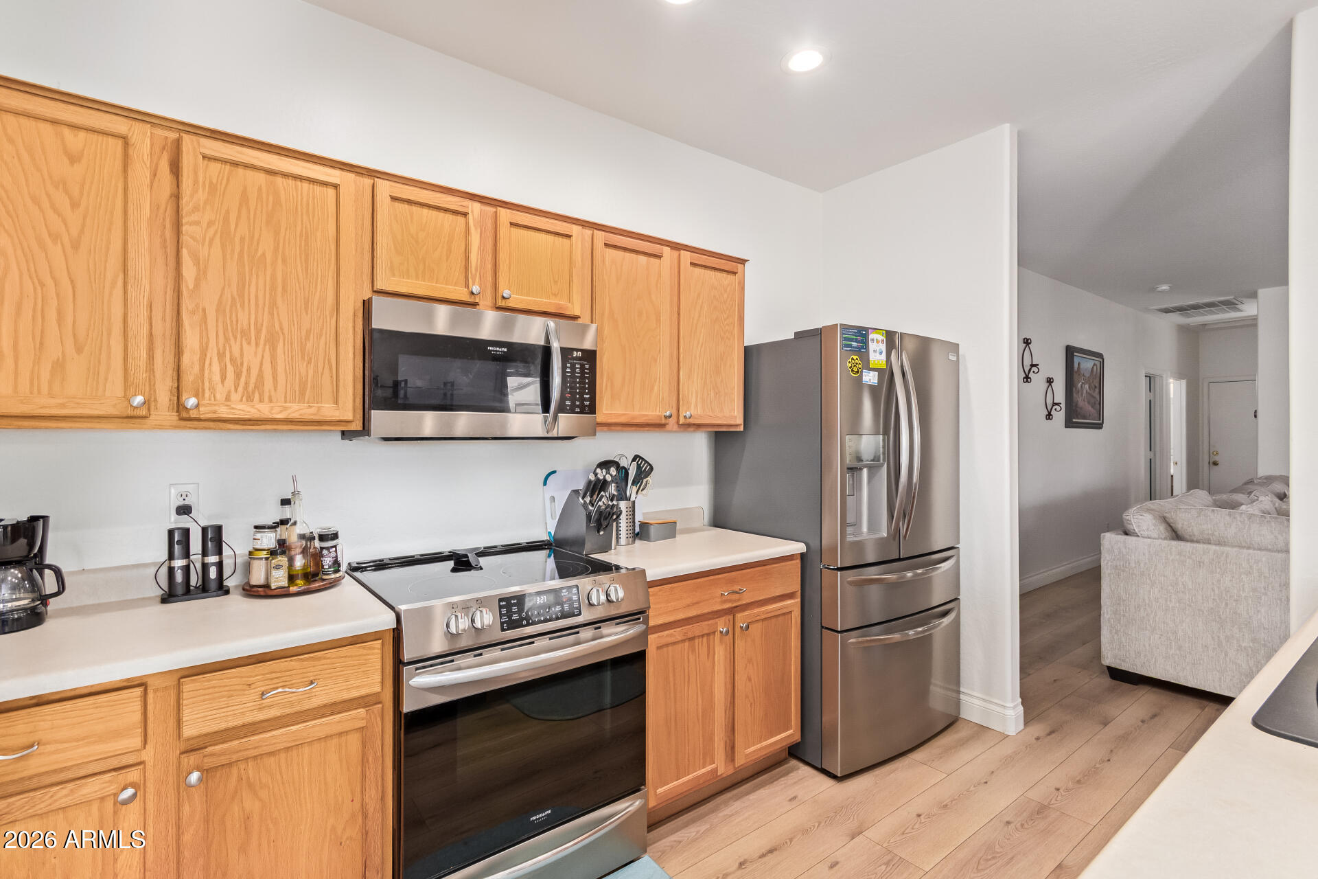 16805 West Rimrock Street Surprise, AZ 85388 - Photo 12 of 42 a kitchen with stainless steel appliances granite countertop a refrigerator stove and sink
