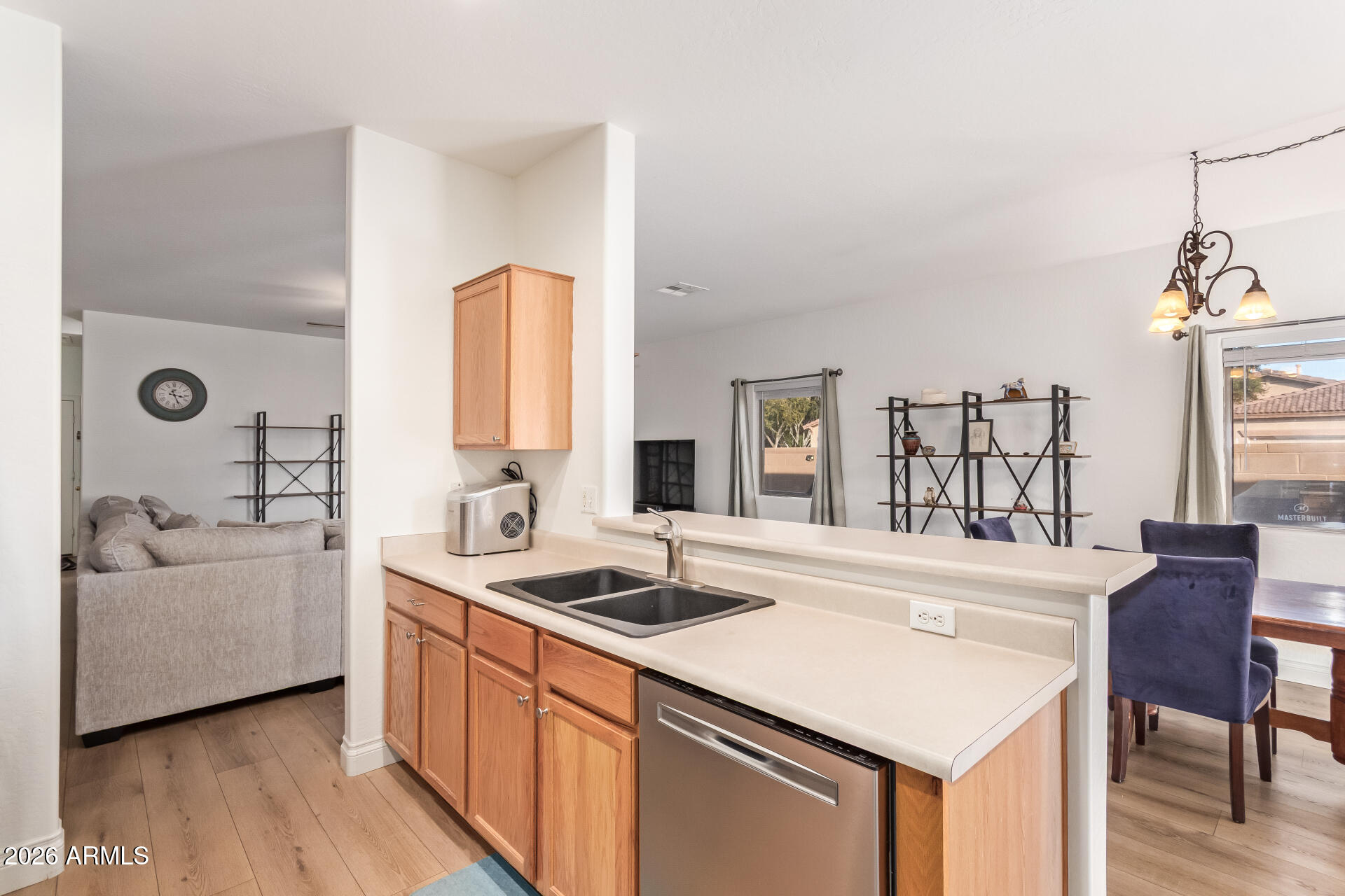 16805 West Rimrock Street Surprise, AZ 85388 - Photo 15 of 42 a kitchen with a sink dishwasher a stove and a refrigerator with wooden floor