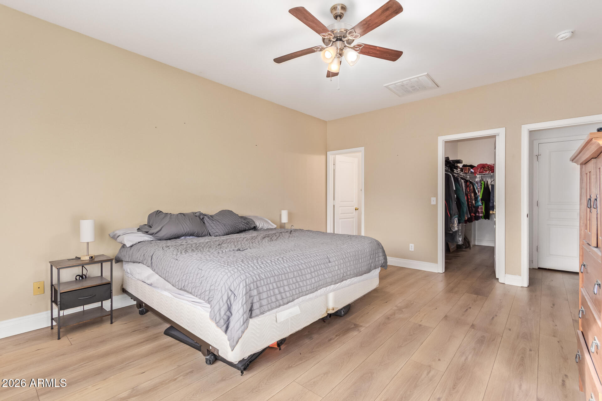 16805 West Rimrock Street Surprise, AZ 85388 - Photo 18 of 42 a spacious bedroom with a bed and a chandelier