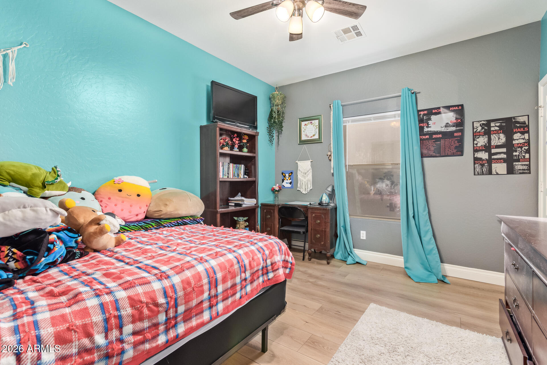 16805 West Rimrock Street Surprise, AZ 85388 - Photo 24 of 42 a bedroom with a bed and a chandelier