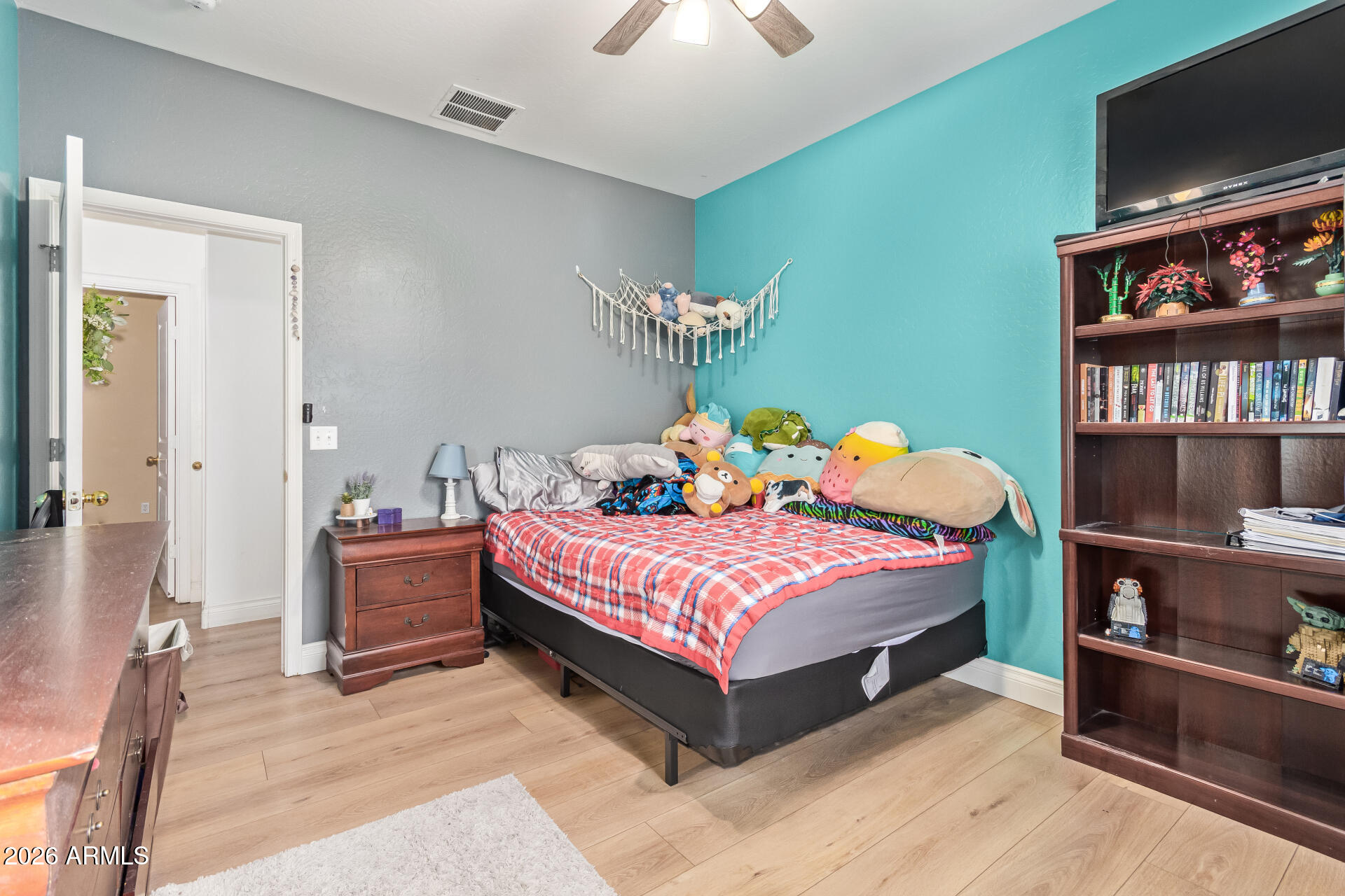 16805 West Rimrock Street Surprise, AZ 85388 - Photo 25 of 42 a bedroom with a bed and a flat screen tv