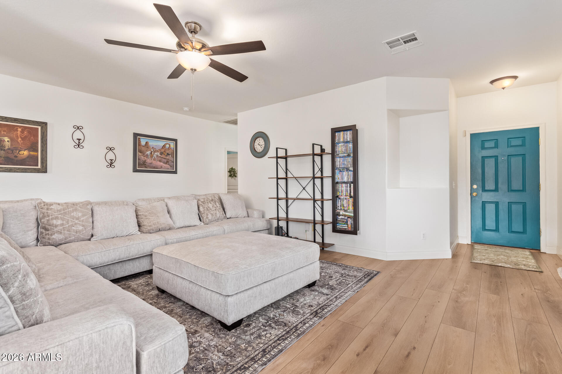 16805 West Rimrock Street Surprise, AZ 85388 - Photo 8 of 42 a spacious bedroom with a bed a couch and a chandelier