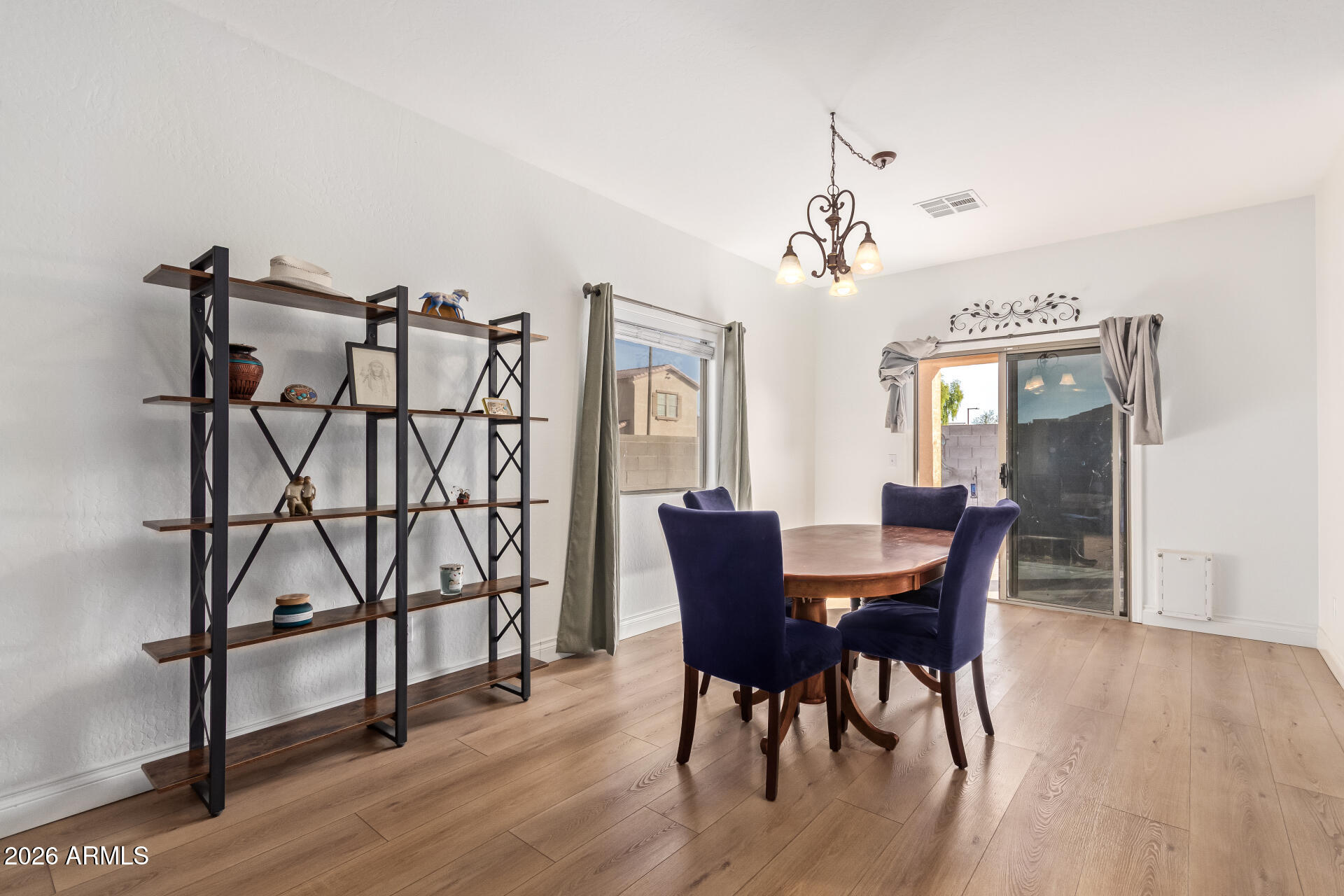 16805 West Rimrock Street Surprise, AZ 85388 - Photo 10 of 42 a view of a dining room with furniture and wooden floor
