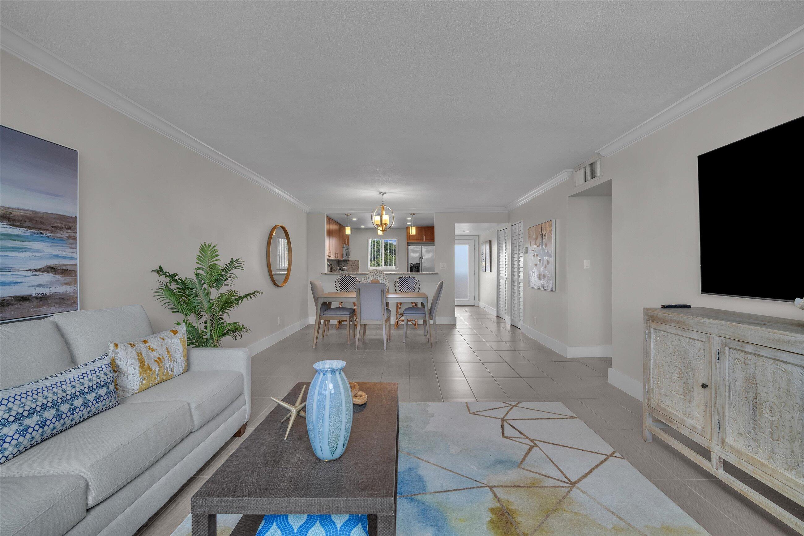 601 North Ocean Boulevard, Unit 203 Boca Raton, FL 33432 - Photo 11 of 20 a living room with furniture and a flat screen tv