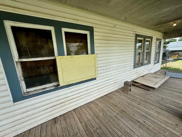 a view of a house with a door and wooden floor