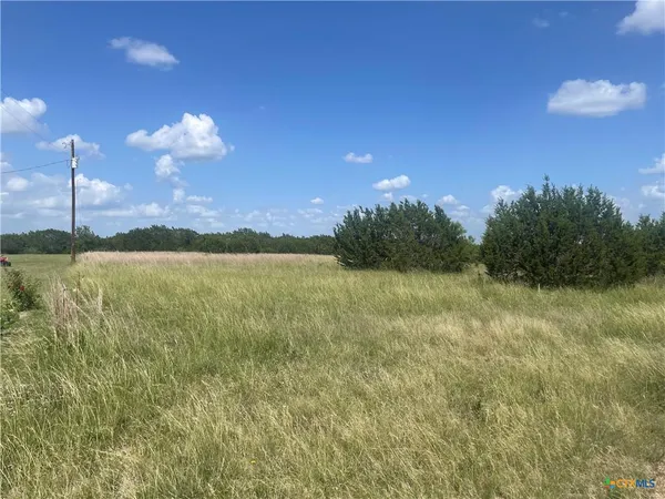 a view of a lake with a yard