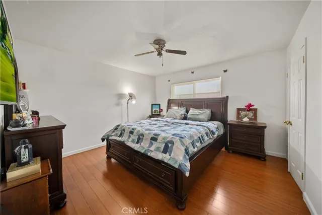 a spacious bedroom with a bed and a chandelier