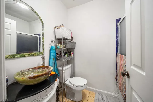 a bathroom with a sink toilet and mirror