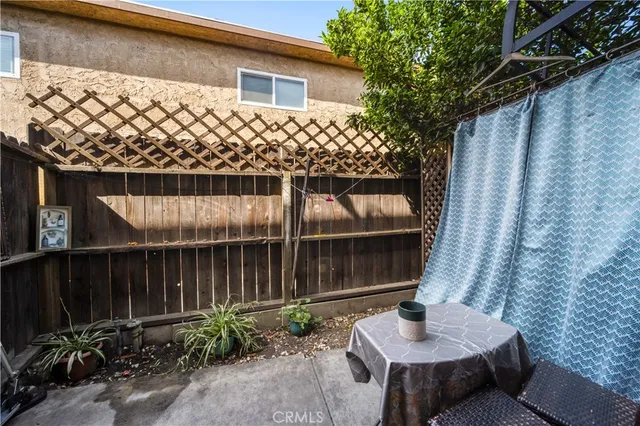 a backyard of a house with table and chairs
