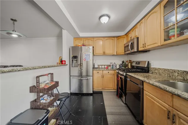 a kitchen with a refrigerator a stove and a sink