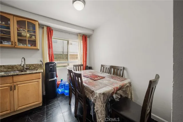 a view of a dining room with furniture and window