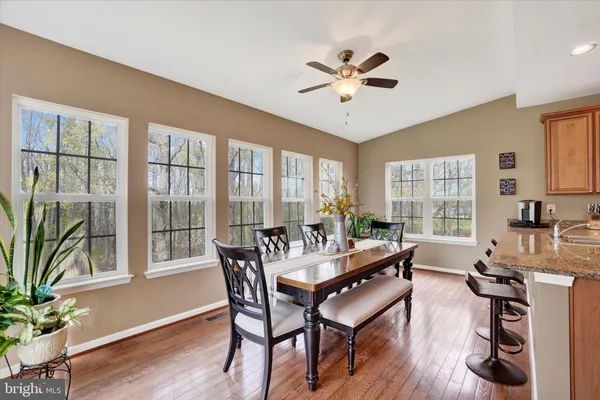 a view of a dining room with furniture window and wooden floor